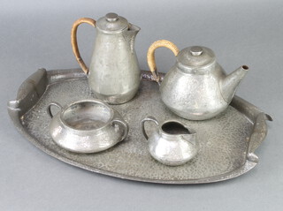 A Liberty and Co hammered pewter tea set stamped 0352 comprising tea pot, hot water jug, cream jug, sugar bowl together with an unstamped pewter twin handled tea tray