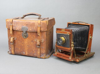 A 19th Century bellows plate camera marked Boots Special together with 6 plate carriers, mahogany and brass carrier marked G Hare Manufacturers 26 Calthorpe Street London, contained in a leather case interior labelled Strand, Hunter and Co. Ltd, 37 Bedford Street, Strand 