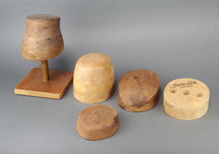 A shaped wooden hat block, the base marked B0788 and oval rubber stamp mark Walker London W1 Marlborough 10cm h x 19cm w x 6cm d on an associated base, 2 squat ditto marked B0881 5cm x 16cm x 14cm and 1660 7cm x 19cm x 15cm, 2 others unmarked 14cm x 16cm x 19cm and 6cm x 9cm x 6cm  (all have pin marks)  
