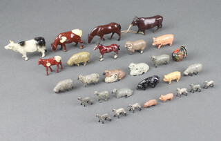 A collection of Britains farmyard figures including cows, sheep, horses and lambs 