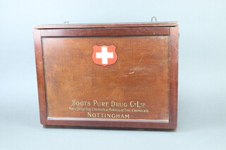 A Boots Pure Drug Company Ltd. wooden wall mounted First Aid Box with fitted interior containing some contents (for decorative purposes only) 36cm h x 49cm w x 12cm d, the front marked Boots Pure Drug Company Ltd Manufacturing Chemists and Makers of Fine Chemicals Nottington 