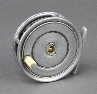 A Hardy 1920's Uniqua 3 3/8" trout fishing reel with horseshoe latch, alloy foot and with ivorine handle 