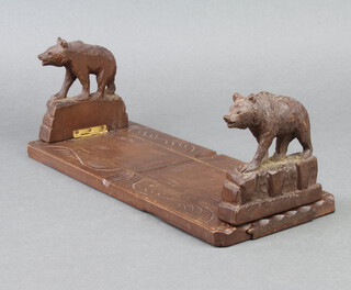 A Swiss expanding bookend carved bears 10cm x 32cm x 13cm 