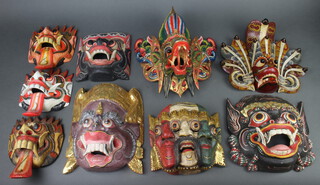 Nine various Eastern carved and painted wooden masks 