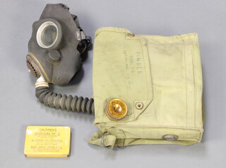 A Second World War military issue respirator together with ointment anti-gas no.2, eye shields anti-gas MK2 in a cardboard case, Outfit anti-dimming Mk4, all contained in a canvas bag 
