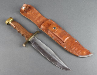Carl Schlieper, a Bowie knife, the 20cm blade marked Bowie Carl Schlieper Solingen Germany with wooden grip and leather scabbard fitted a sharpening stone 