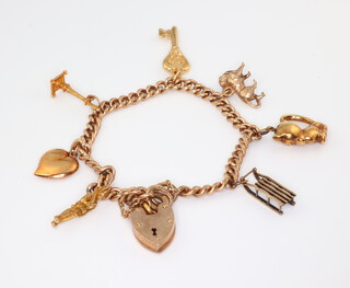 A 9ct yellow gold charm bracelet and heart shaped padlock 29 grams gross