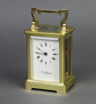 Wellington, a 20th Century English 8 day carriage clock with enamelled dial and Roman numerals contained in a gilt case 11cm x 7cm x 6cm complete with key 