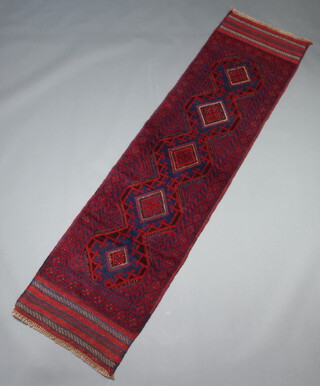 A blue and red ground Meshwani rug with 5 diamonds to the centre within a multi row border 247cm x 63cm 