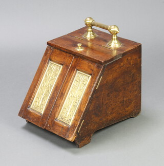 An Edwardian oak and brass banded coal box with patented hinged lid 30cm h x 30cm w x 41cm d 