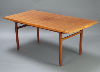 A mid-Century teak dining table with chamfered edge, raised on turned supports 73cm h x 90cm w x 176cm l when closed, with extra leaf 225cm l 

