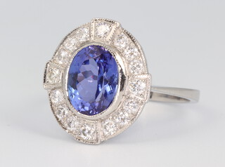 A white metal stamped plat. Art Deco style oval tanzanite and diamond cluster ring, the centre stone 2.25ct, the diamonds 0.6ct, 4.9 grams, size M 