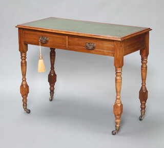 An Edwardian mahogany writing table with inset tooled green leather writing surface fitted 2 drawers raised on turned supports ending in casters 80cm h x 104cm w x 50cm d s