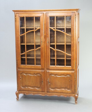 A French oak display cabinet fitted adjustable shelves enclosed by astragal glazed panelled doors, the base enclosed by panelled doors 65cm h x 115cm w x 53cm d  