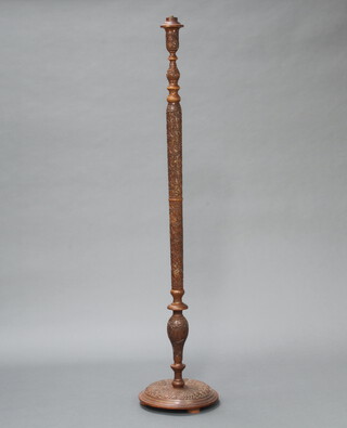 A 1930's carved Eastern hardwood standard lamp raised on a circular base 155cm h x 33cm diam. 