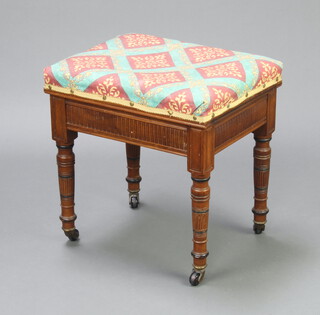 An Edwardian walnut box seat piano stool with upholstered seat raised on turned and fluted supports 49cm h x 47cm w x 37cm d 