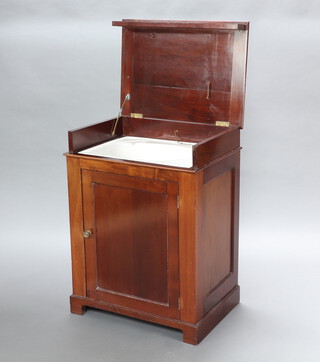 A 19th Century mahogany enclosed washstand, the hinged lid revealing a hand basin above a cupboard enclosed by panelled door, raised on a platform base 86cm h x 64cm w x 46cm d 