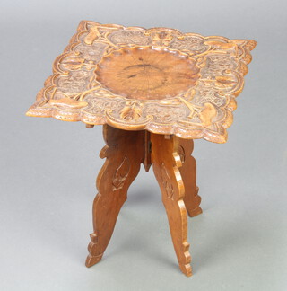 A 1930's square Eastern carved hardwood occasional table raised on a folding stand 39cm h x 35cm w x 34cm d  
