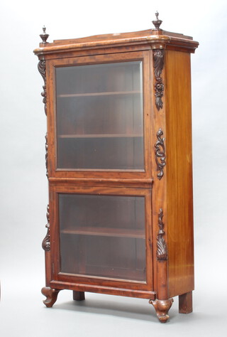 A 19th Century Continental mahogany display cabinet enclosed by bevelled plate panelled doors having scroll decoration to the side, raised on scrolled feet 162cm h x 90cm w x 40cm d 
