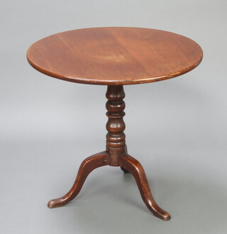 A 19th Century circular mahogany snap top tea table, raised on turned column and tripod base 70cm h x 73cm diam. 
