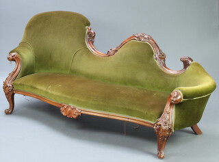 A Victorian rosewood show frame sofa, heavily carved throughout, the seat of serpentine outline raised on cabriole supports 93cm h x 214cm w x 68cm d (seat 165cm w x 48cm d)  