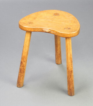 Robert Thompson, "Mouseman", an oak 3 legged stool the seat edge carved a mouse and raised on chamfered supports 46cm h x 40cm x 38cm d 