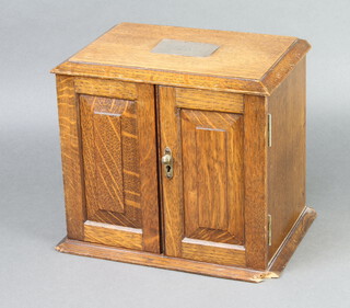 A Victorian oak stationery box with silver plaque to the lid, stepped interior, the base with 2 drawers enclosed by a panelled door 24cm h x 26cm w x 18cm d 