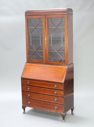 An Edwardian inlaid mahogany bureau bookcase, the upper section fitted shelves enclosed by astragal glazed doors, the fall front revealing a well fitted interior above 4 long drawers, raised on cabriole supports 191cm h x 91cm w x 42cm d 