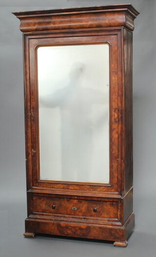 A 19th Century Continental walnut armoire with moulded cornice, enclosed by a bevelled plate mirror panelled doors, the base fitted a drawer above a secret drawer 207cm h x 106cm w x 51cm d 