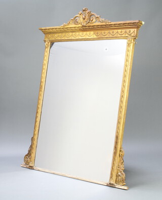 A 19th Century rectangular plate over mantel mirror contained in a decorative gilt frame with swag decoration 157cm h x 125cm w x 8cm d 