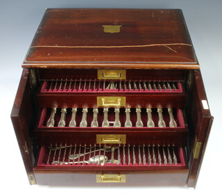 An extensive matched Victorian silver canteen of lily pattern cutlery by George Adams comprising 6 egg spoons London 1871 and 1875 monogrammed, 6 tea spoons London 1855 monogrammed, 6 tea spoons London 1859 and 1871, 6 tea spoons London 1853 with crest, 8 tea spoons London 1853 and 1866 with crest, 2 mustard spoons and 1 caddy spoon rubbed marks, salt spoon London 1864, 4 tea spoons London 1846, 2 measuring spoons London 1843 and 1856, 12 dinner forks London 1857, 1858 and 1868 with crests, 16 dessert forks London 1858, 12 table spoons with crests London 1856, 1857, 12 dessert spoons London 1858 with crest, 2 ladles 1 with crest 1 without London 1856 and 1863, a serving spoon London 1871, pair of serving spoons London 1857 and 1860, 2 small forks London 1854, a salt spoon London 1877, a ladle London 1852 with crest and a butter knife London 1855, total 5926grms (12 dessert knives, 12 dinner knives, 12 fish knives, 12 fish forks) contained in a mahogany canteen with brass escutcheon and inset carrying handles, the door with carved scroll decoration enclosing 4 fitted drawers with brass inset handles