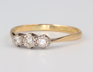A yellow metal 18ct 3 stone diamond ring, approx. 0.10ct, size P, 2gms
