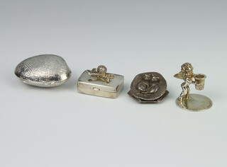 A white metal shell box, a small box the lid decorated golf clubs and golf ball, a miniature stand of a cherub holding a thimble and a lid decorated two cats in a basket