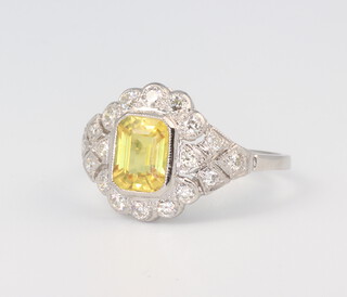 A white metal stamped Plat. yellow sapphire and diamond cluster ring, the centre stone 1.55ct, the brilliant cut diamonds 0.5ct, size M 1/2, 4.4gms