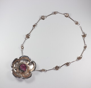 A cast silver floral pendant on a ditto chain, the centre of the pendant set with jewels, London 1979, 84gm, maker S J H 
