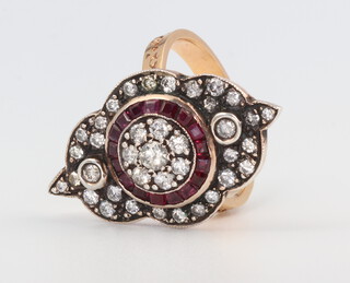 An Edwardian style yellow metal ruby and diamond ring, the brilliant cut diamonds approx. 1.18ct, the ruby 0.58ct, 10gms, size O 
