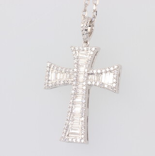 A white metal baguette and brilliant cut diamond cross pendant 28mm x 18mm suspended on an 18ct white gold chain 42cm, gross weight 6gms 
