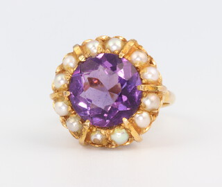 A yellow metal stamped 9ct circular amethyst and seed pearl dress ring, size K 1/2, 6.6gms