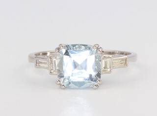 A white metal stamped Plat. aquamarine and diamond ring, the centre stone approx. 2ct, the baguette cut diamonds 0.25ct, 4.3gms, size O 1/2