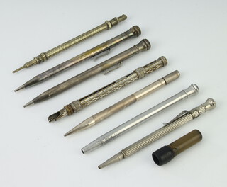 An engine turned silver propelling pencil (a/f) and 6 others 