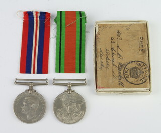 A pair of World War Two medals comprising Defence medal and British War medal in original posting box to S P Marshall