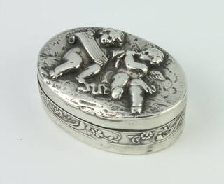 A 925 standard oval repousse pill box decorated with cherubs, 4.5cm, 38 grams 