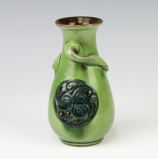A Brannam Barum pottery vase with twist handles and decorated roundels, impressed marks Liberty & Co, 14cm