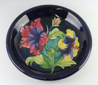 A William Moorcroft shallow blue ground plate decorated with flowers with Queen Mary label, monogram and impressed mark 21cm 