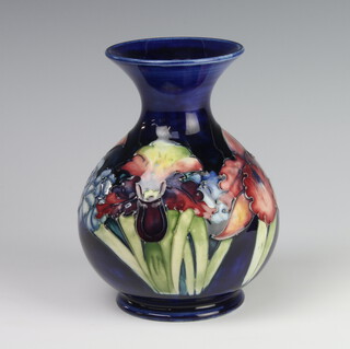 A William Moorcroft baluster vase, the blue ground decorated with flowers, Queen Mary label, monogram and impressed mark 17cm 