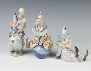 A Lladro figure of a clown sitting on a ball 5813 17cm, ditto of a balloon seller 5811 17cm and a seated ditto 5812 11cm 