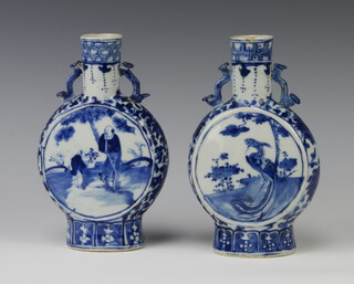A pair of late 19th Century Chinese blue and white moon shaped vases decorated with panels of birds and flowers with dragon handles 21cm 