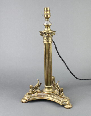 A Victorian reeded gilt metal oil lamp base with Corinthian capital triform base supported by sphynx 37cm x 25cm, converted to a table lamp 