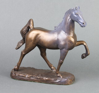 After M King, a bronzed figure of a prancing horse, the base marked M King 1987 24cm x 20cm x 7cm 