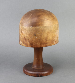 A turned wooden hat block on a associated stand, the base marked 201 22, 28cm x 18cm x 14cm 